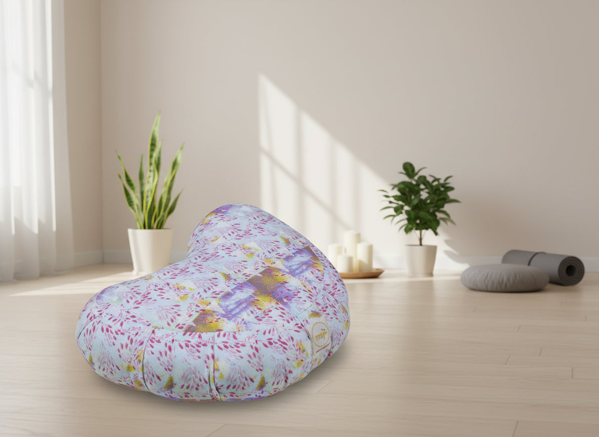Heart-shaped pillow with colorful floral pattern on a white background