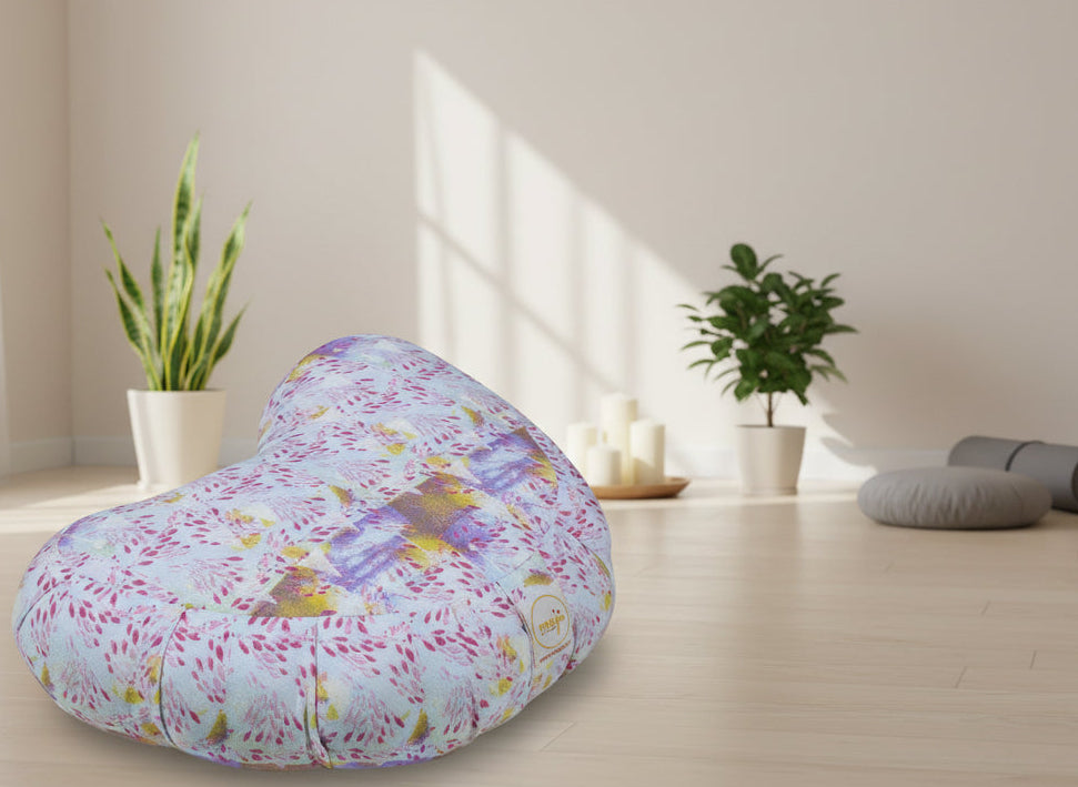 Heart-shaped pillow with colorful floral pattern on a white background