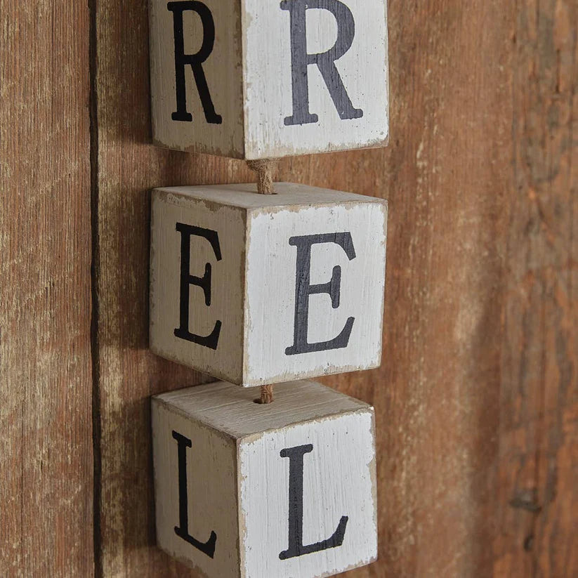 Wooden blocks with letters spelling 'REEL' on a wooden background
