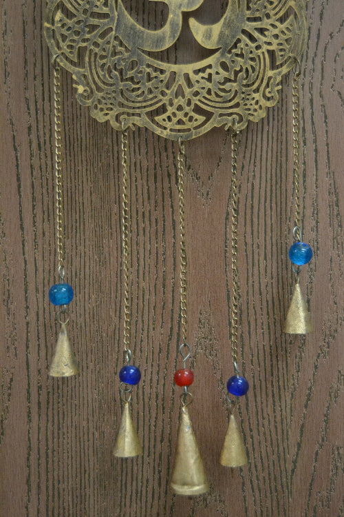 Decorative hanging ornament with blue and red beads on a wooden background